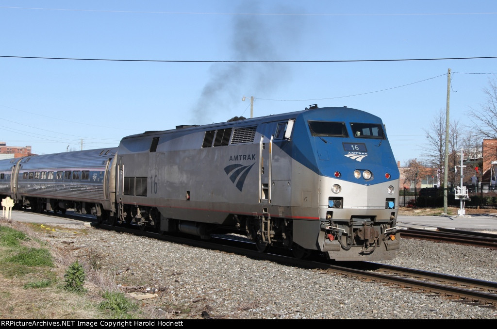 AMTK 16 leads train 80 away from the station